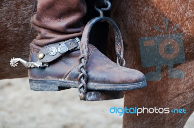 Cowboy Boot With Spur And Horse Stock Photo