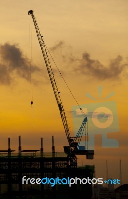 Crane Of Building Construction On Dusky Sky Stock Photo