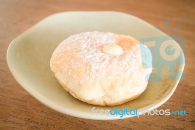 Cream Donut On Vintage Background Stock Photo