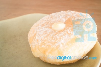 Cream Donut On Vintage Background Stock Photo