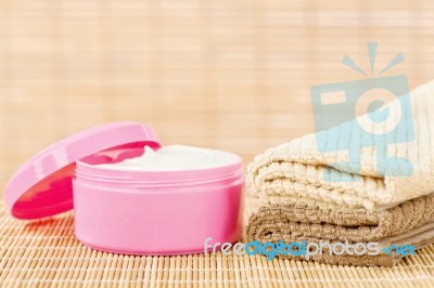 Cream In Pink Cup With Towels Stock Photo