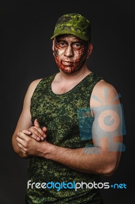 Creative And Funny Military Style Camouflage On Tankman Face Stock Photo