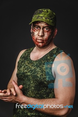 Creative And Funny Military Style Camouflage On Tankman Face Stock Photo