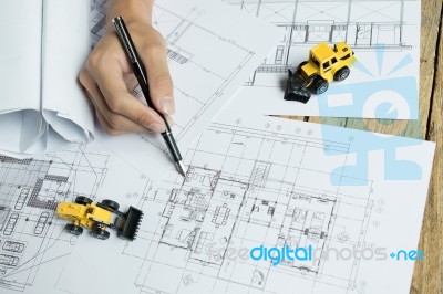 Creative Architect Projecting On The Big Drawings In The Dark Lo… Stock Photo