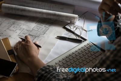 Creative Architect Projecting On The Big Drawings In The Dark Lo… Stock Photo