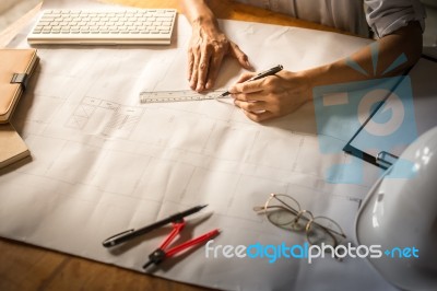 Creative Architect Projecting On The Big Drawings In The Dark Lo… Stock Photo