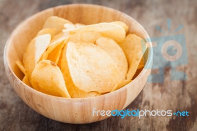 Crispy Potato Chips On Wooden Background Stock Photo