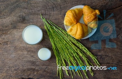 Croissant On Dish With Rice Milk And Ear Of Rice  On Old Wooden Stock Photo