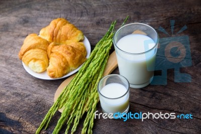 Croissant On Dish With Rice Milk And Ear Of Rice  On Old Wooden Stock Photo