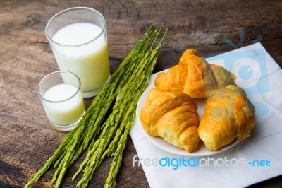 Croissant On Dish With Rice Milk And Ear Of Rice  On Old Wooden Stock Photo