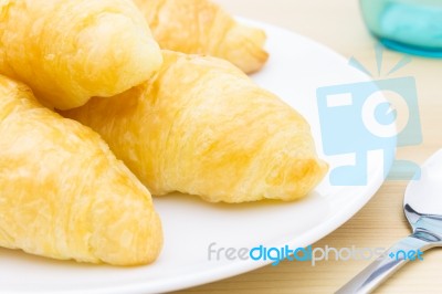 Croissant Or Bread On White Dish On Wood Table And Glass And Spo… Stock Photo