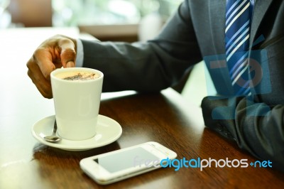 Cropped Image Of Businessman At Coffee Shop Stock Photo