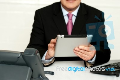 Cropped Image Of Businessman Using Tablet Pc Stock Photo