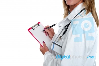 Cropped Image Of Doctor Writing On Clipboard Stock Photo