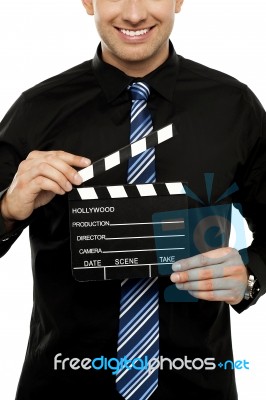 Cropped Image Of Man With Clapboard Stock Photo