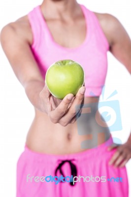 Cropped Image Of Woman Showing Apple Stock Photo