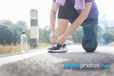 Cropped Shot Of Young Women Runner Tightening Running Shoe Laces… Stock Photo