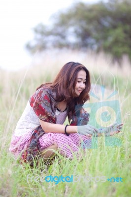 Crouching Young Girl In Outdoors Stock Photo