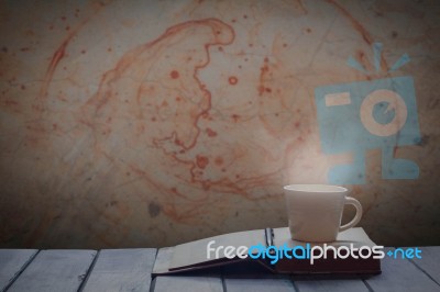 Cup And Book Beside The Wall Stock Photo