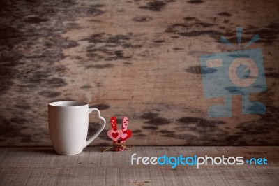 Cup And Heart With Love On Wooden Floor Stock Photo