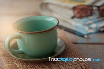 Cup And Stationery On Desk Stock Photo