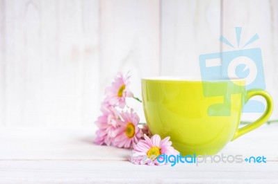 Cup Of Black Coffee And Daisy Flowers On The White Table Stock Photo