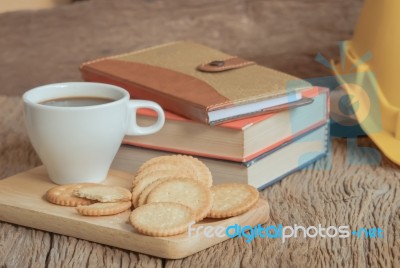 Cup Of Coffee And Cracker With Book On Old Wood Table Stock Photo