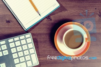 Cup Of Coffee And Notebook On A Wooden With Vintage Colour Stock Photo