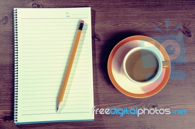 Cup Of Coffee And Notebook On A Wooden With Vintage Colour Stock Photo