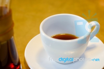 Cup Of Coffee On White Plate And Wood Table Background Stock Photo