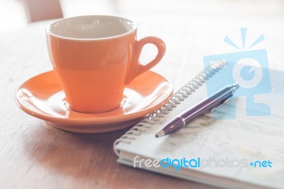 Cup Of Coffee With Pen And Spiral Notebook Stock Photo