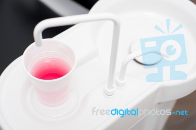 Cup Of Juice In Dental Clinic Stock Photo