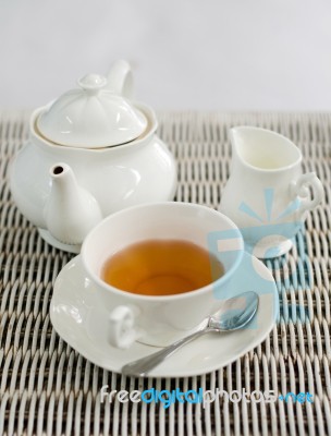 Cup Of Tea With Little Milk Jar And Teapot Stock Photo