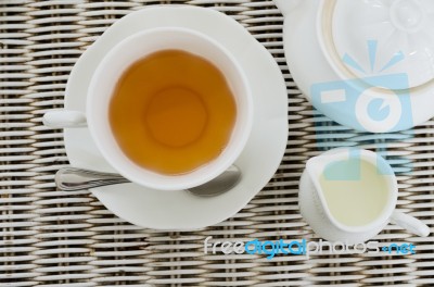 Cup Of Tea With Little Milk Jar And Teapot Stock Photo