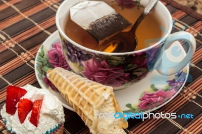 Cup Of Tea With Pastry After Dinner Stock Photo