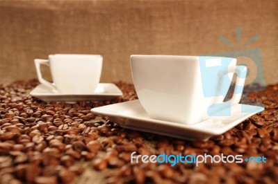 Cups With Coffee And Coffee Beans Stock Photo