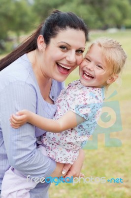 Curious Mother Carrying Her Daughter With Big Smile Stock Photo