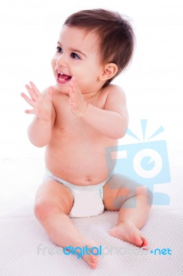 Cute Baby Sitting And Enjoying Stock Photo