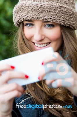 Cute Brunette Woman Taking Photo Of Herself On The Street Stock Photo