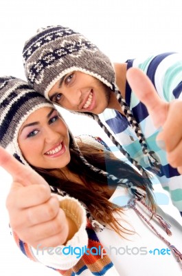 Cute Couple Wearing Warm Cap Showing Thumbs Up Stock Photo