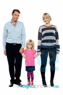 Cute Daughter Holding Hands Of Her Parents Tightly Stock Photo