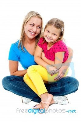 Cute Daughter Sitting In Mother's Lap Stock Photo