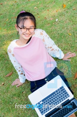 Cute Girl Is Happy With Notebook On Grass Stock Photo