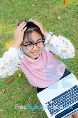 Cute Girl Is Happy With Notebook On Grass Stock Photo