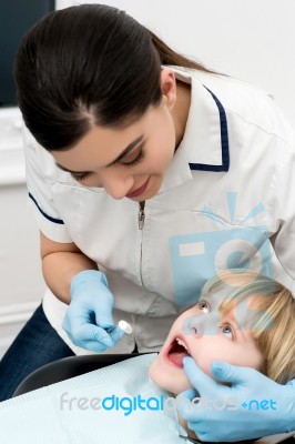 Cute Kid Getting Dental Checkup Stock Photo