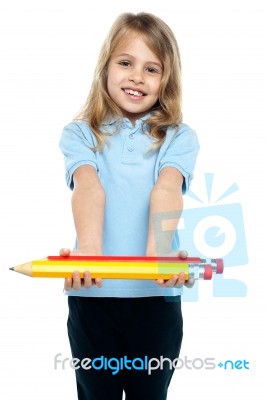 Cute Kid In Casuals Holding Colorful Pencils Stock Photo