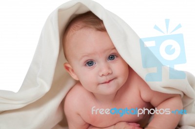 Cute Little Baby Lying Under Blanket Stock Photo