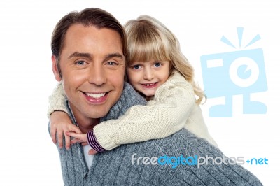 Cute Little Daughter Piggybacking Her Father Stock Photo