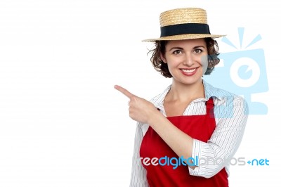 Cute Woman In Hat Pointing Sideways Stock Photo