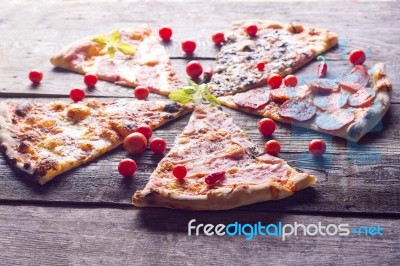 Cutted Pizza On Wooden Table Stock Photo